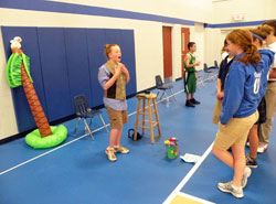 Avalin Senefeld, left, impersonates Gene Stratton-Porter, the author of A Girl of the Limberlost, during the St. Luke School Wax Museum on May 14. Fourth-grade students researched Indiana historical figures and presented two-minute speeches about their lives while students and parents listened. (Photo by Kamilla Benko)