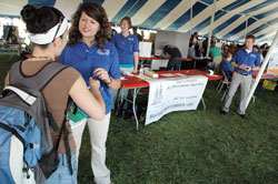 Fellowship of Catholic University Students missionary Anne Marie Brummer, right, explains a survey given to an Indiana University-Purdue University Indianapolis student during an activities fair held on Sept. 1 on the school’s campus. Standing behind Brummer are FOCUS missionaries Alexandra Kale, left, and Matthew Johnson. (Photo by Sean Gallagher)