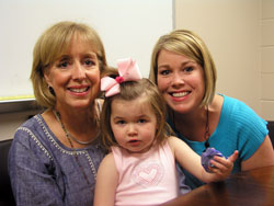 A first-grade teacher at St. Pius X School in Indianapolis, Jeanine Ritter, left, started an effort at the school to collect 1 million pop can tabs for the Ronald McDonald House in Indianapolis. The school reached its goal this spring. Ritter is shown with her niece, Katie Chamness, right, and Katie’s daughter, Gabby. (Photo by John Shaughnessy)