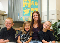 Megan Ward says that Indiana’s school voucher system has created new educational hopes and possibilities for her three school-aged children, who now attend Holy Spirit School in Indianapolis. Her children are Matthew, left, Amiya and Olan. (Photo by John Shaughnessy)