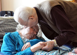 St. Augustine Home for the Aged resident Donald Bird of Indianapolis kisses his wife, Mary, on June 7 in her room at the home operated by the Little Sisters of the Poor. They celebrated their 75th wedding anniversary on June 20 then God called him home on June 27 at age 98. (Photo by Mary Ann Garber)