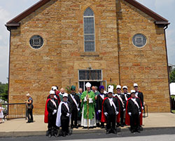 Following the sesquicentennial Mass at St. Mark Parish in Perry County, Bishop Christopher J. Coyne poses with members of the Bishop Chartrand Council #1172 Knights of Columbus, who provided an honor guard for the celebration.	(Photo by Patricia Happel Cornwell)