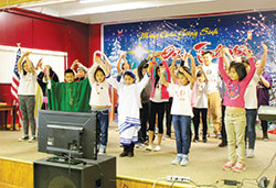 Children from the archdiocesan Vietnamese Catholic Congregation take the stage on Nov. 27 in Elford Hall at St. Joseph Parish in Indianapolis. The performance was part of the west side parish’ s commemoration of the Feast of the Holy Vietnamese Martyrs. (Photo by Victoria Arthur) 