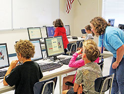 In this photo from June 28, 2016, Laura Swessel, a science teacher at Our Lady of Providence Jr./Sr. High School in Clarksville, works with fourth‑through sixth-graders participating in the school’s summer STEM Camp, which is open to all students in the New Albany Deanery. (Submitted photo)