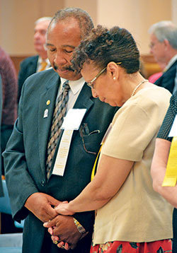 Deacon Oliver and Cora Jackson share a moment of silent prayer while renewing their nuptial vows at the archdiocesan Golden Wedding Jubilee Mass at SS. Peter and Paul Cathedral in Indianapolis on Aug. 5.  (Photo by Natalie Hoefer)