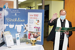 Archbishop Charles C. Thompson blesses Birthline Ministry’s new space in the Xavier Building, 1435 N. Illinois St., on the campus of the Archbishop Edward T. O’Meara Catholic Center in Indianapolis on Oct. 7. (Photo by John Shaughnessy)