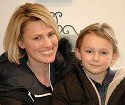 Milla Burkholder and her mother Jacqueline are all smiles on March 16 after delivering a $470 donation to help the homeless. Milla raised the money by setting up a lemonade stand in front of her house. (Photo by John Shaughnessy)