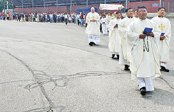 A eucharistic procession is seen making its way around the campus of Roncalli High School in Indianapolis on July 9 as part of the National Zomi American Eucharistic Congress held at the school on July 8-10. (Photo by Natalie Hoefer)