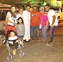 Felix Navarrete, right, and his wife Paholla, fourth from left, three of their children and his parents pose on March 27, 2018, with Bishop Rolando Alvarez in Matagalpa, Nicaragua. (Submitted photo)