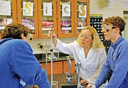 Amanda Horan shows the joy that teaching brings her as she works with students during a lab in the Honors Chemistry class she teaches at Bishop Chatard High School in Indianapolis. Horan is this year’s recipient of the Saint Theodora Excellence in Education Award, the highest honor given to an educator in the archdiocese. (Photo by John Shaughnessy)