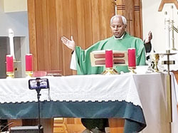 Father Francis Kalapurackal celebrates Mass on Oct. 22, 2020, at St. Thomas More Church in Mooresville. As a priest born and ordained in India but now serving as a priest of the Archdiocese of Indianapolis, Father Kalapurackal, currently pastor of St. Pius X Parish in Indianapolis, seeks to promote priestly vocations among those born here. (Submitted photo)