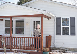 Holly Stewart, director of Birthright of Delphi since 1999, stands on the porch of the house that will be the new home for the organization. (Photo by Caroline B. Mooney)