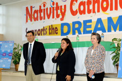 Photo caption: Abraham Brown, Celina Weataherwax and Pilar Tirado welcome participants to a forum at the Juan Diego Center at Nativity Church in Evansville July 22. Brown is the parish director of youth ministry. Weatherwax is on the staff of Senator Richard Lugar. Tirado assists in parish ministry to the Spanish speaking. (Message photo by Paul R. Leingang)