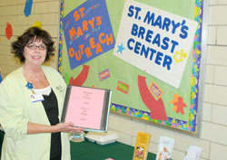 Dawnelle Neighbors awaits visitors to her booth at St. John the Apostle, to discuss breast health and cancer awareness. (Message photo by Paul R. Leingang) 