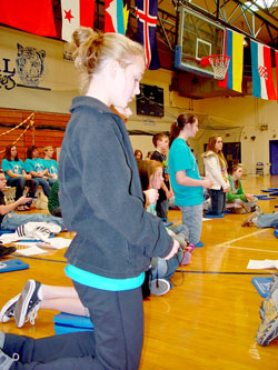 Alyssa Singer, a parishioner at Corpus Christi Church in Evansville, prays the Chaplet of Divine Mercy during the 2011 Source and Summit youth retreat in Evansville. (Message photo by Mary Ann Hughes)